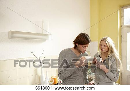 Young couple drinking coffee in kitchen View Large Photo Image Stock Image - Young couple drinking coffee in kitchen . Fotosearch