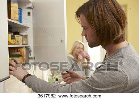 Young couple in kitchen View Large Photo Image Stock Image - Young couple in kitchen . Fotosearch