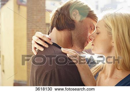 Stock Image - Young couple kissing . Fotosearch