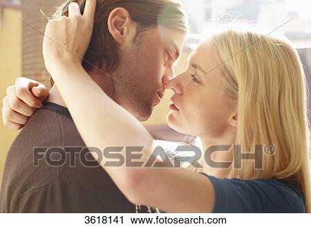 Young couple kissing View Large Photo Image Stock Image - Young couple kissing . Fotosearch
