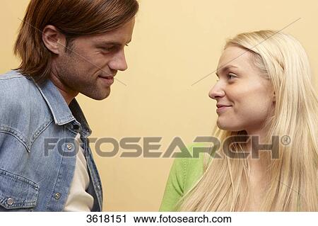 Young couple smiling at each other View Large Photo Image Stock Image - Young couple smiling at each other . Fotosearch