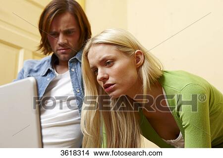 Young couple using laptop View Large Photo Image Picture - Young couple using laptop . Fotosearch
