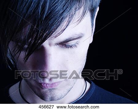 Young man looking down View Large Photo Image Stock Photo - Young man looking down . Fotosearch