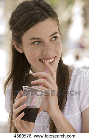 Stock Photograph - Young woman drinking cola . Fotosearch