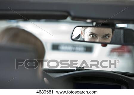 Stock Image - Young woman driving car . Fotosearch