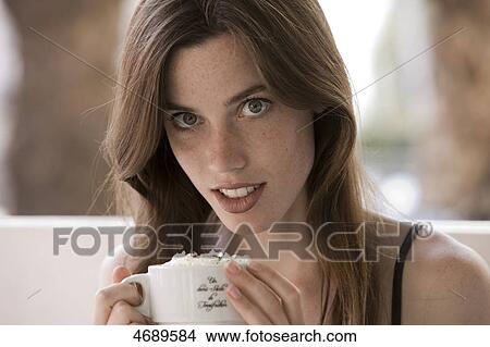 Young woman holding cup View Large Photo Image Picture - Young woman holding cup . Fotosearch