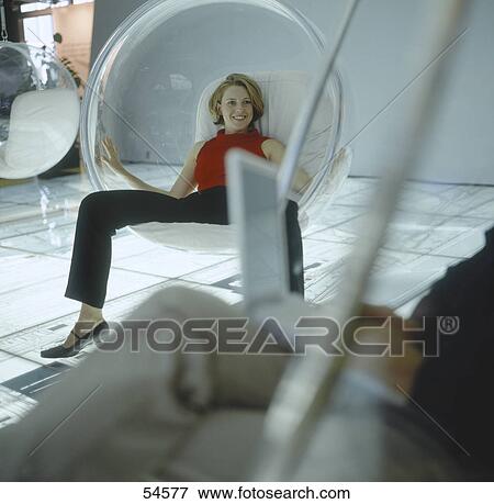 Stock Photo - Young woman looking at businessman using laptop . Fotosearch