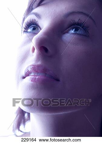 Young woman looking up, portrait View Large Photo Image Picture - Young woman looking up, portrait . Fotosearch