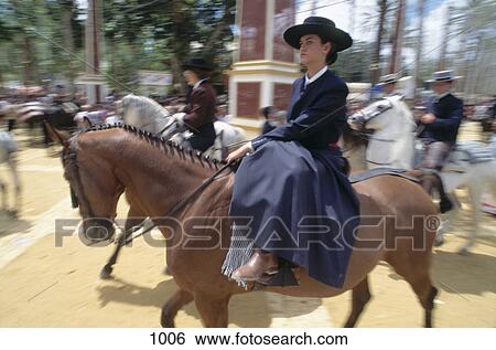 Stock Photograph - Young woman riding horse in festival, Jerez De La Frontera, Andalusia, Spain . Fotosearch