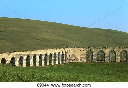 Picture - Ancient aqueduct on landscape, Tranquinia, Tuscany, Italy . Fotosearch