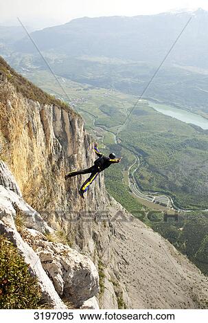 BASE jumper free falling, Arco, Monte Brento, Italy View Large Photo Image Stock Photography - BASE jumper free falling, Arco, Monte Brento, Italy . Fotosearch