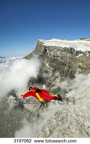 Stock Image - BASE jumper with wingsuit, Les Diablerets, Switzerland . Fotosearch