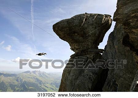 Stock Image - Basejumper free falling, Eiger North Face, Switzerland . Fotosearch