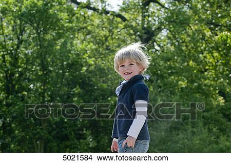 Blond boy playing outside View Large Photo Image Picture - Blond boy playing outside . Fotosearch