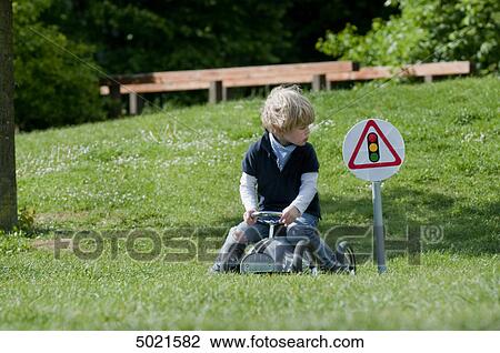 Blond boy playing outside View Large Photo Image Stock Image - Blond boy playing outside . Fotosearch