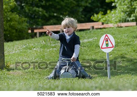 Stock Image - Blond boy playing outside . Fotosearch