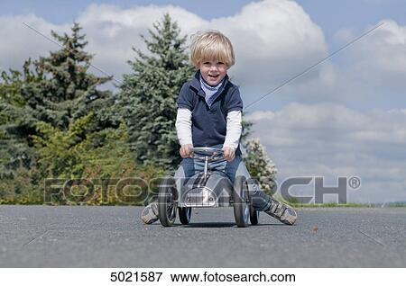 Stock Photo - Blond boy playing outside . Fotosearch