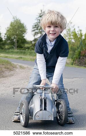 Blond boy playing outside View Large Photo Image Stock Photograph - Blond boy playing outside . Fotosearch