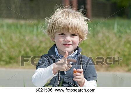 Blond boy playing outside View Large Photo Image Stock Photograph - Blond boy playing outside . Fotosearch