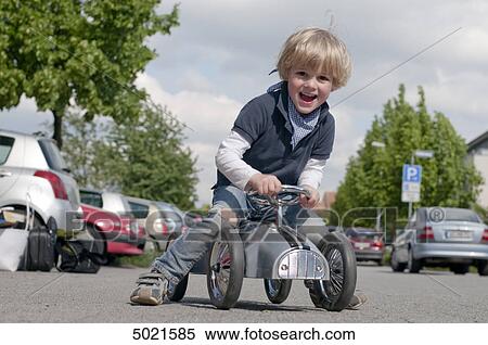 Stock Photography - Blond boy playing outside . Fotosearch
