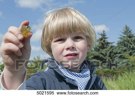 Stock Photography - Blond boy playing outside . Fotosearch