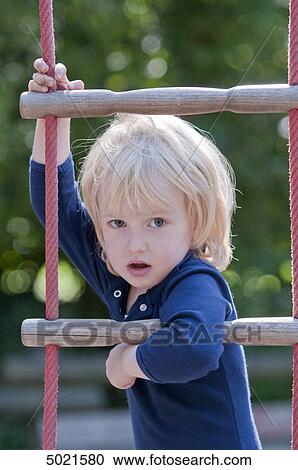 Stock Image - Blond girl at playground . Fotosearch