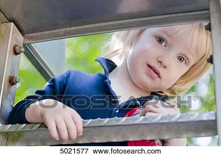 Stock Photo - Blond girl at playground . Fotosearch