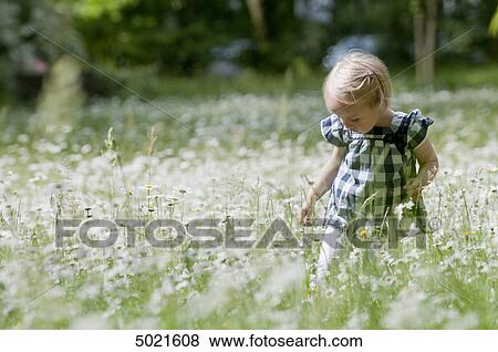 Blond girl on a flower meadow View Large Photo Image Stock Photo - Blond girl on a flower meadow . Fotosearch