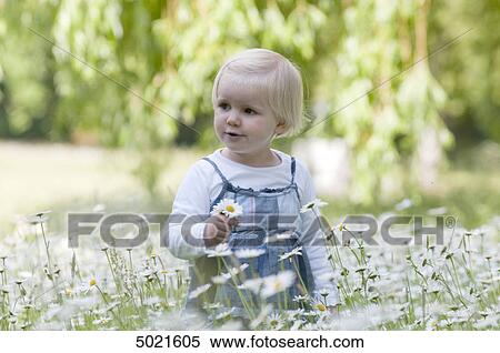 Blond girl on a flower meadow View Large Photo Image Stock Photography - Blond girl on a flower meadow . Fotosearch