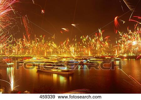 Boats at harbor with fireworks in background, Cologne, Germany View Large Photo Image Stock Photo - Boats at harbor with fireworks in background, Cologne, Germany . Fotosearch