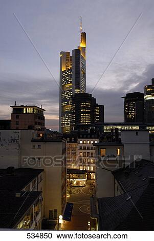 Buildings in city lit up against evening sky, Commerzbank, Frankfurt, Germany View Large Photo Image Stock Image - Buildings in city lit up against evening sky, Commerzbank, Frankfurt, Germany . Fotosearch
