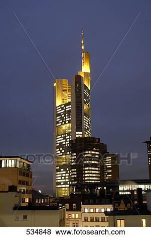 Buildings in city lit up against evening sky, Commerzbank, Frankfurt, Germany View Large Photo Image Stock Photo - Buildings in city lit up against evening sky, Commerzbank, Frankfurt, Germany . Fotosearch