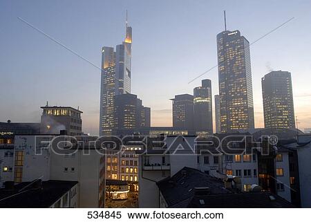 Buildings in city lit up against evening sky, Frankfurt, Germany View Large Photo Image Stock Photography - Buildings in city lit up against evening sky, Frankfurt, Germany . Fotosearch