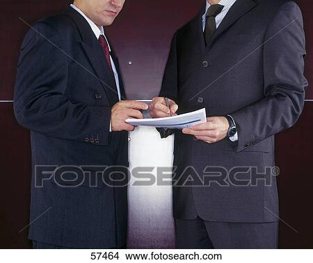 Businessmen discussing documents in meetings View Large Photo Image Picture - Businessmen discussing documents in meetings . Fotosearch