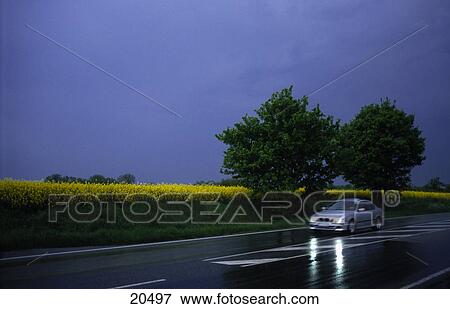 Car on wet street View Large Photo Image Stock Photo - Car on wet street . Fotosearch