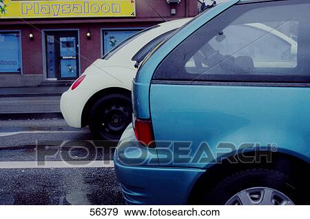 Cars parked at roadside View Large Photo Image Stock Photo - Cars parked at roadside . Fotosearch