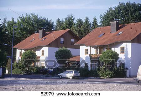 Cars parked in front of houses View Large Photo Image Stock Photo - Cars parked in front of houses . Fotosearch