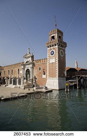 Stock Image - Clock tower and museum at canal side, Museo Storico Navale, Arsenale, Veneto, Venice, Italy . Fotosearch