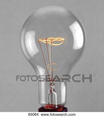 Picture - Close-up of burning filament of light bulb . Fotosearch