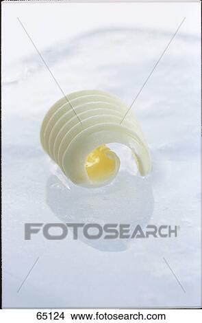 Picture - Close-up of butter on ice . Fotosearch