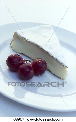 Close-up of cheese cake and grapes on plate View Large Photo Image Stock Photo - Close-up of cheese cake and grapes on plate . Fotosearch