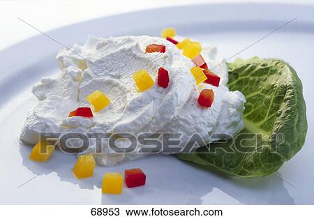 Stock Image - Close-up of chopped bell peppers and curd cheese on plate . Fotosearch
