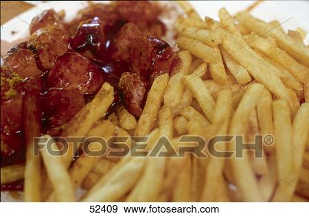 Close-up of curried sausage and French fries View Large Photo Image Stock Photo - Close-up of curried sausage and French fries . Fotosearch