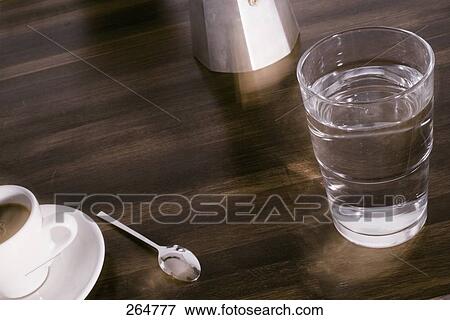 Stock Photo - Close-up of glass of water and cup of coffee . Fotosearch