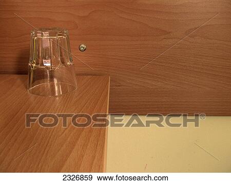 Stock Photo - Close-up of glass on side table in hotel room . Fotosearch