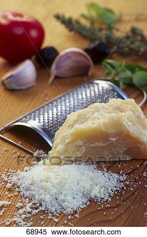 Close-up of grated cheese and cheese grater View Large Photo Image Stock Photography - Close-up of grated cheese and cheese grater . Fotosearch