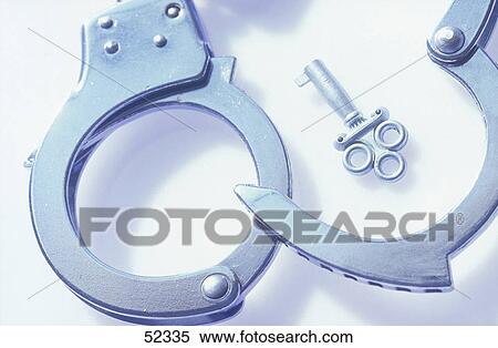 Stock Photography - Close-up of handcuff on white background . Fotosearch