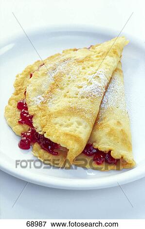 Stock Photo - Close-up of jam filled pancakes . Fotosearch