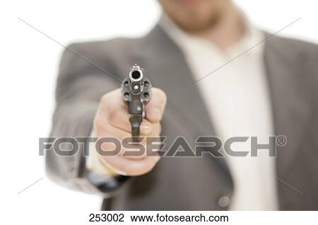 Stock Image - Close-up of man pointing revolver . Fotosearch