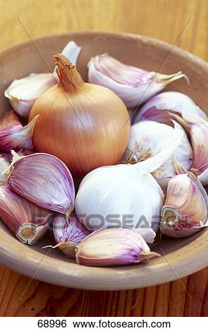 Stock Photograph - Close-up of onion and garlic in bowl . Fotosearch